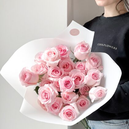 A beautiful bouquet of fresh pink roses with soft, delicate petals, arranged elegantly for a romantic and charming gift.