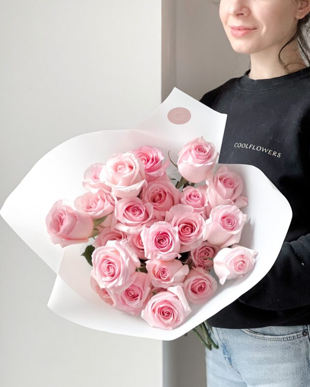 A beautiful bouquet of fresh pink roses with soft, delicate petals, arranged elegantly for a romantic and charming gift.